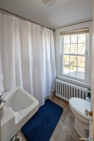 a bathroom with a sink a mirror and a shower curtain