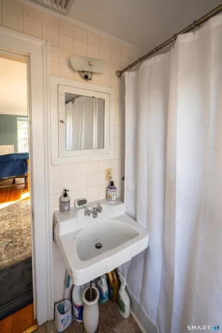 a bathroom with a sink toilet and mirror
