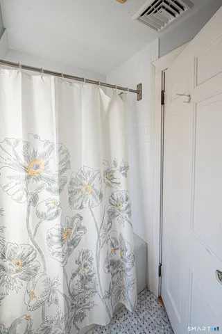 a view of a hallway with wooden floor and stairs