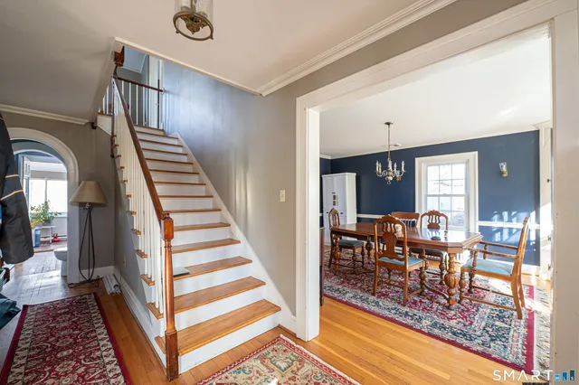 a backyard of a house with wooden floor and outdoor seating