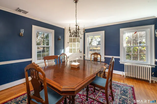 a view of a dining room with furniture window and wooden floor