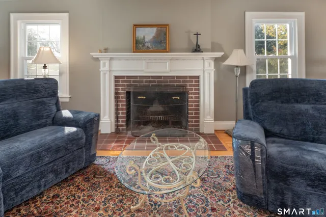 a living room with furniture a window and a fireplace