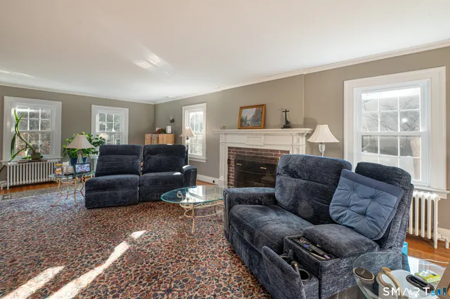 a living room with furniture and a fireplace