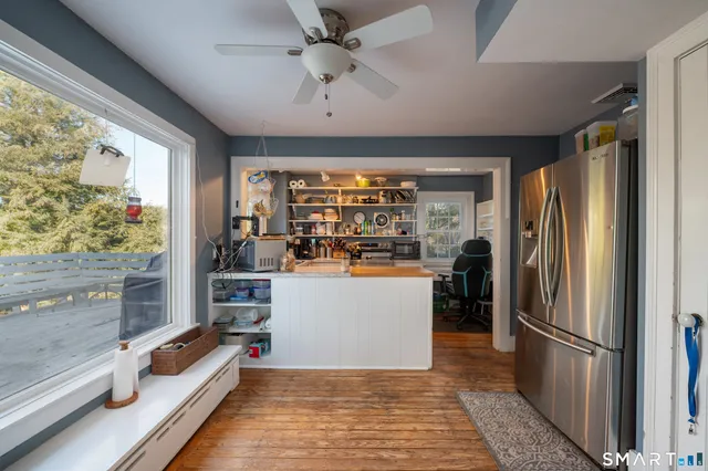 a open kitchen with stainless steel appliances granite countertop a refrigerator and a stove