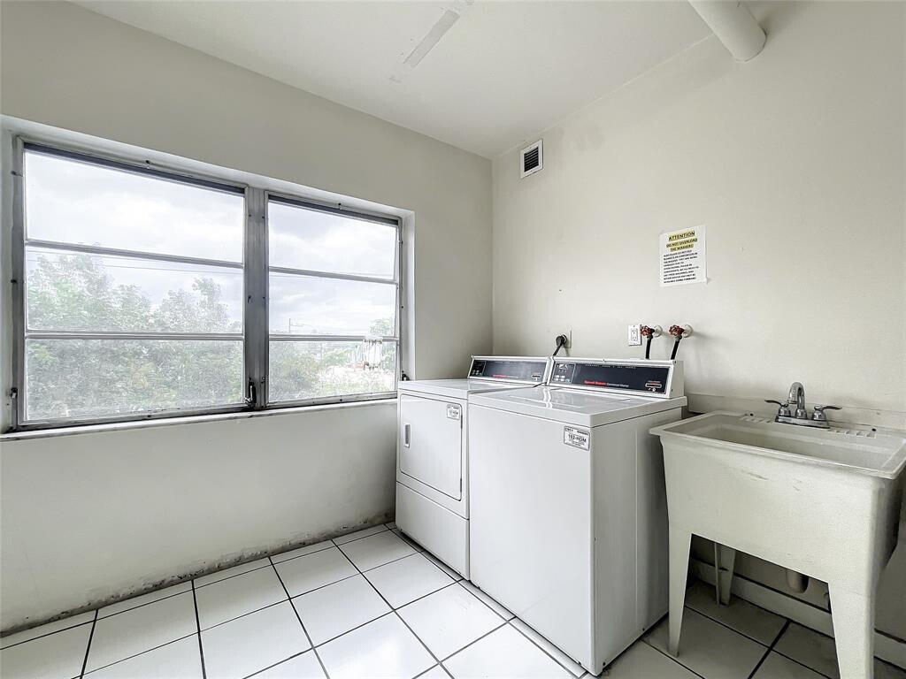 55 Southwest 2nd Avenue, Unit 509 Boca Raton, FL 33432 - Photo 18 of 20 a utility room with a sink dryer and washer