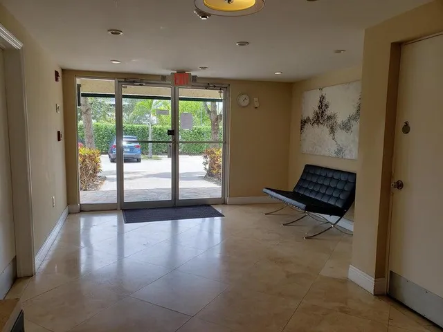 a view of front door with wooden floor and a rug