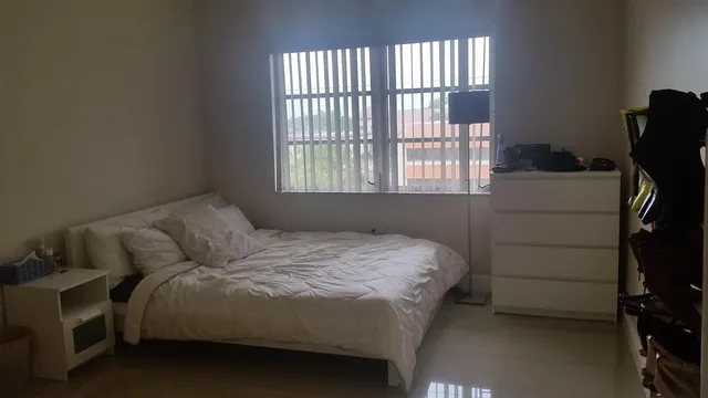a bedroom with a bed and a window