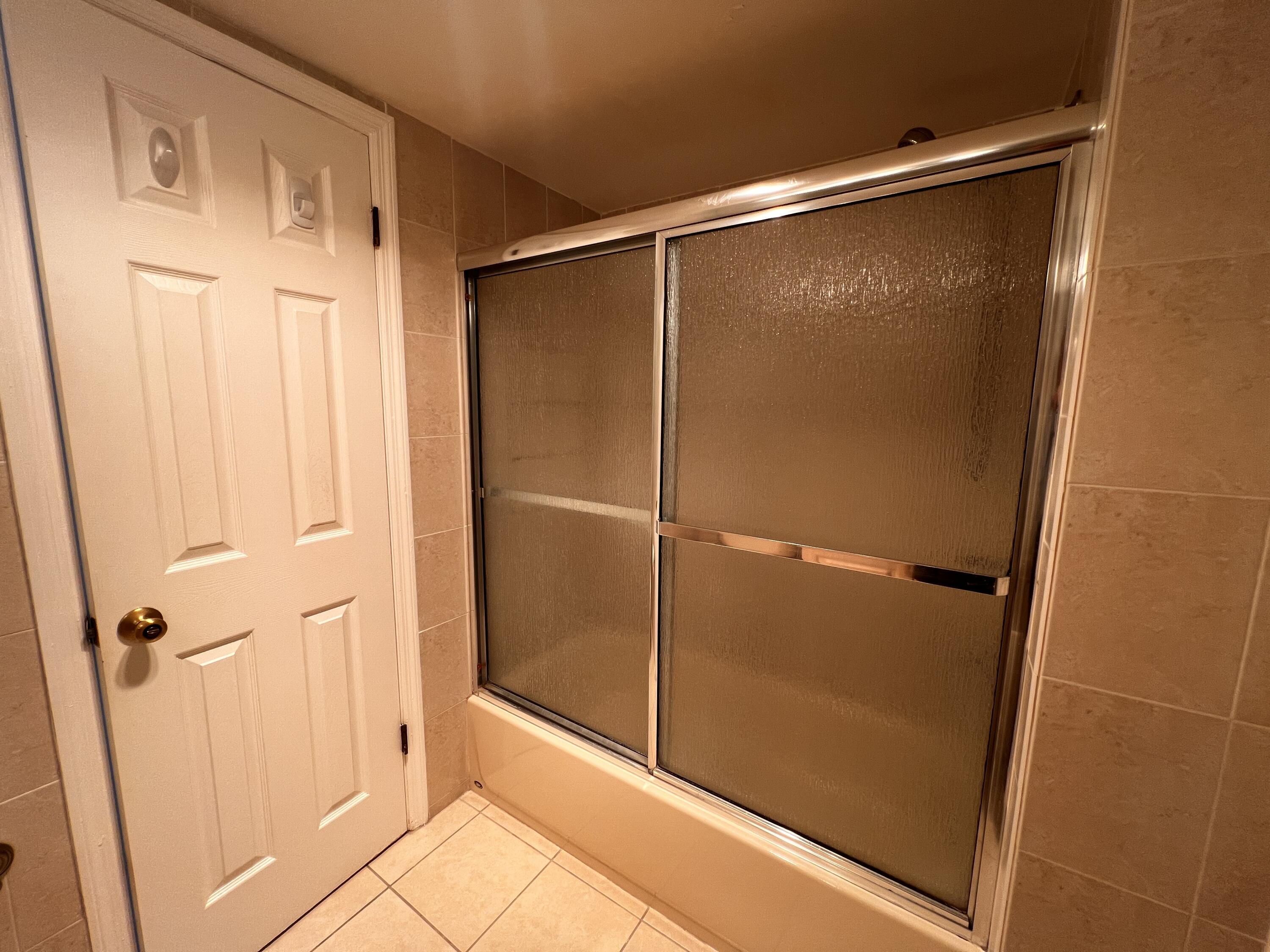 55 Southwest 2nd Avenue, Unit 509 Boca Raton, FL 33432 - Photo 10 of 20 a bathroom with a glass door shower