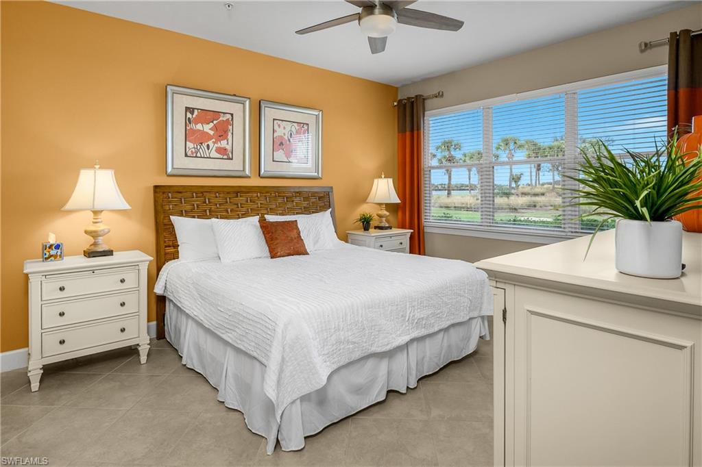 9064 Siesta Bay Drive, Unit 5102 Naples, FL 34120 - Photo 17 of 46 Primary bedroom is spacious with a wall filled with windows allowing natural light to spill in providing stunning views from morning to night.