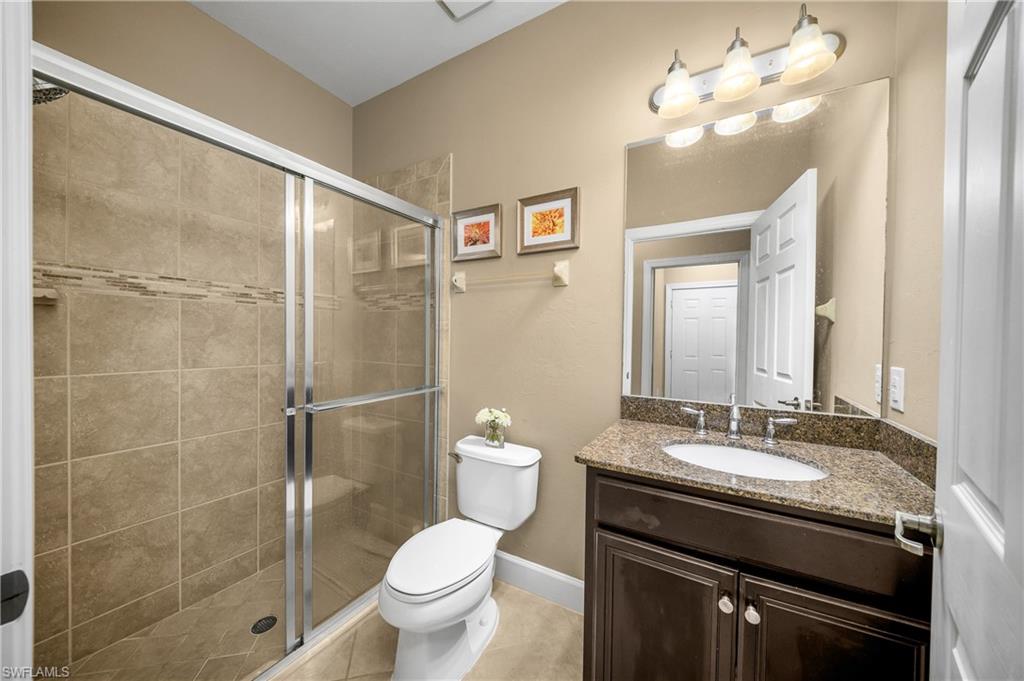 9064 Siesta Bay Drive, Unit 5102 Naples, FL 34120 - Photo 23 of 46 Guest bathroom features a walk-in shower.