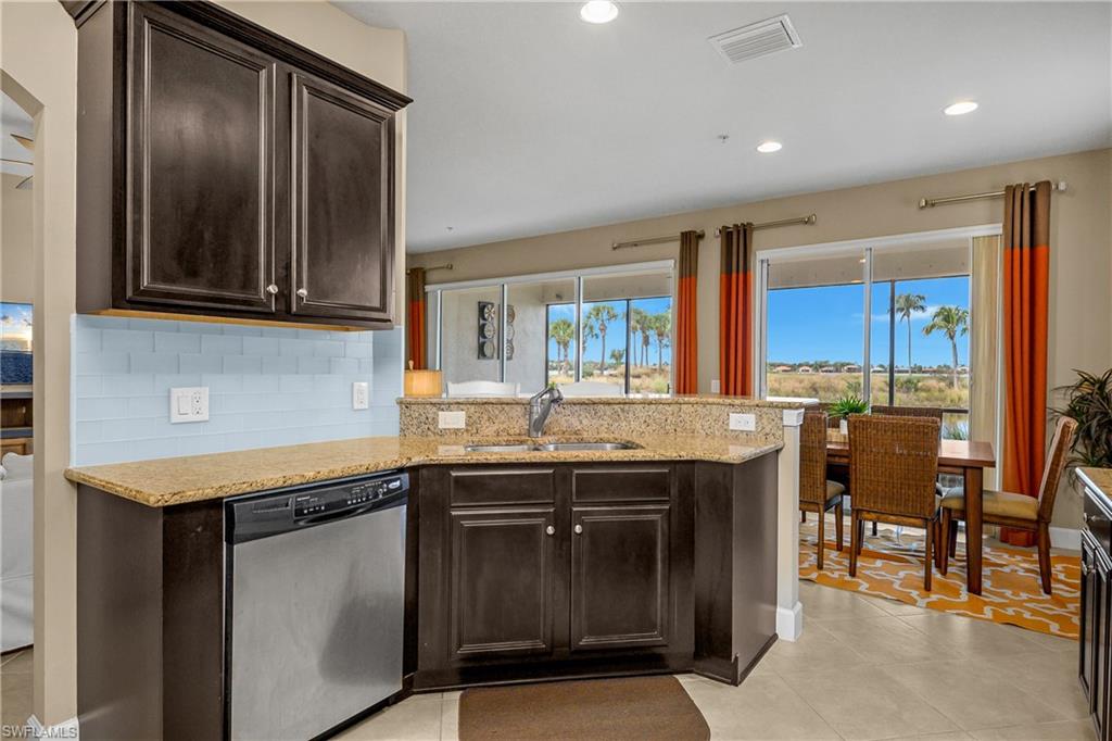 9064 Siesta Bay Drive, Unit 5102 Naples, FL 34120 - Photo 7 of 46 Open kitchen/dining/living area make this space perfect for entertaining guests.