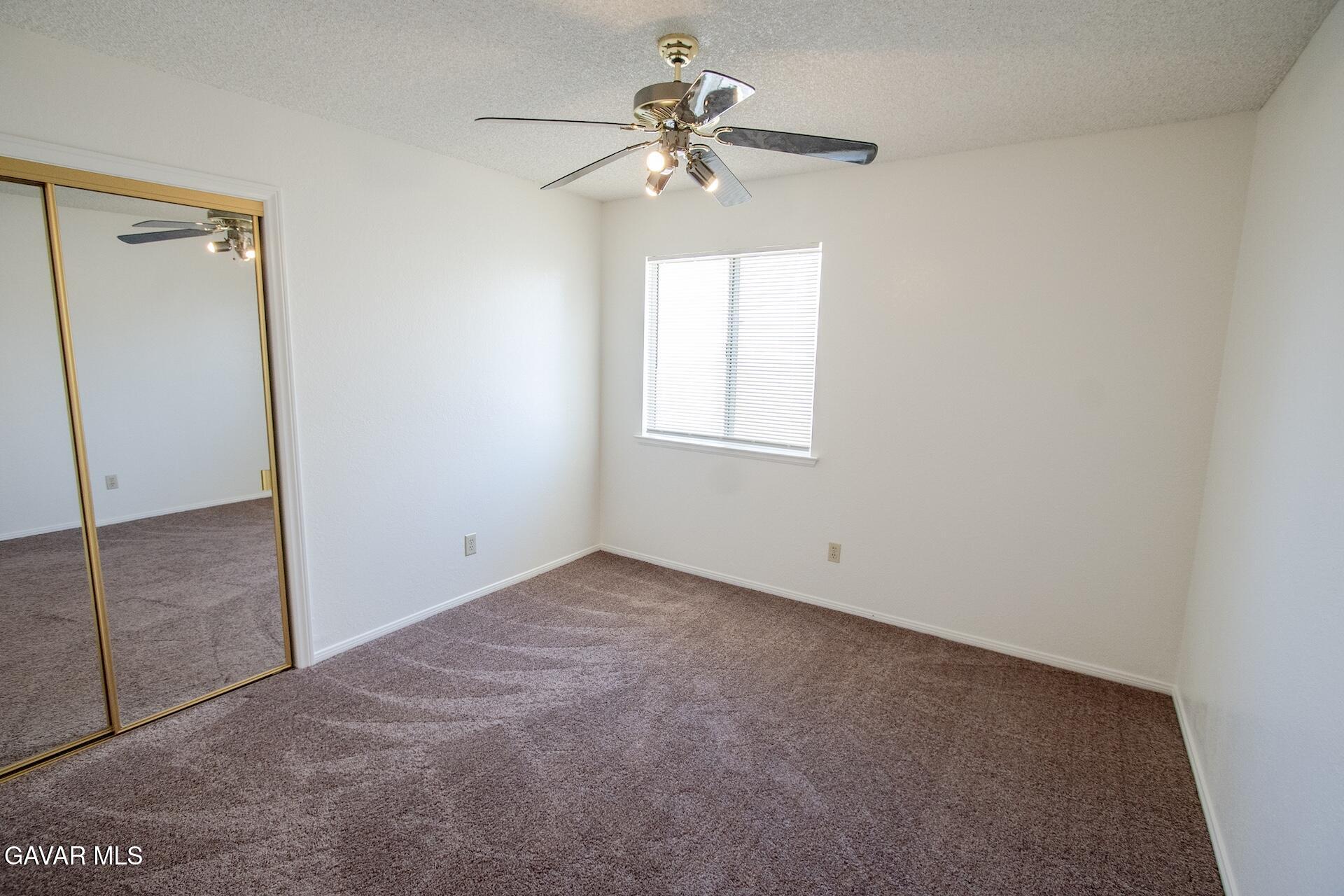 44318 33rd Street West Lancaster, CA 93536 - Photo 27 of 29 an empty room with a window and a fan