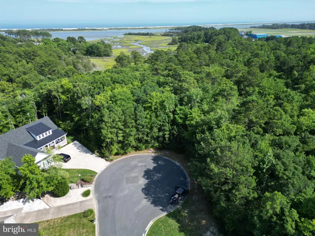 an aerial view of a house with yard