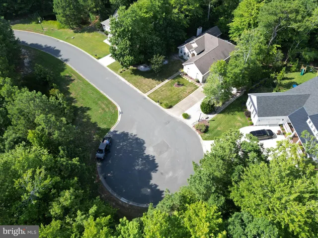 an aerial view of a house with outdoor space and street view
