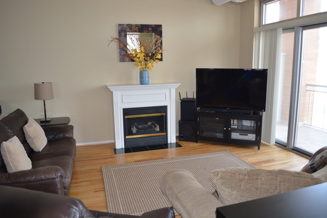 950 West Monroe Street, Unit 704 Chicago, IL 60607 - Photo 3 of 6 a living room with furniture and a flat screen tv