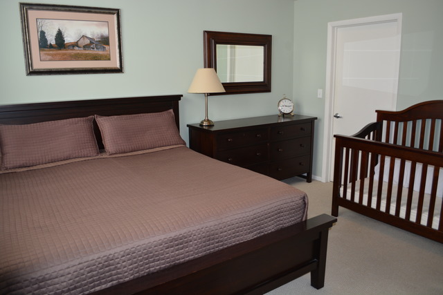 950 West Monroe Street, Unit 704 Chicago, IL 60607 - Photo 4 of 6 a bedroom with a bed and night stand