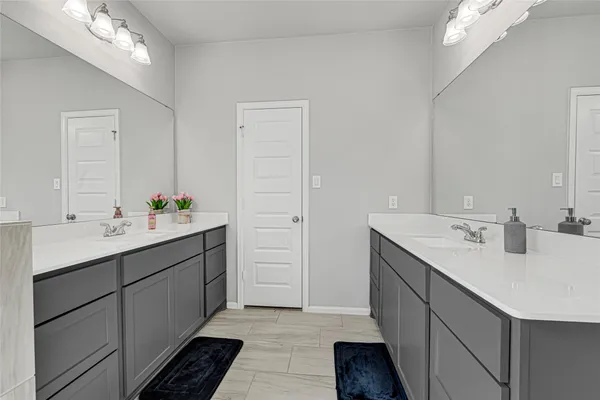 a bathroom with a sink double vanity and a mirror