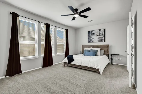 a bedroom with a large bed and a window