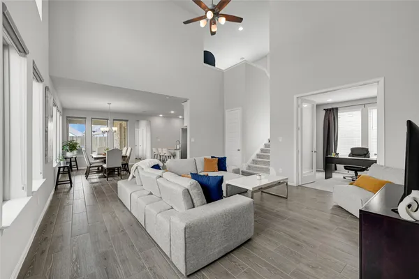 a living room with furniture and a wooden floor