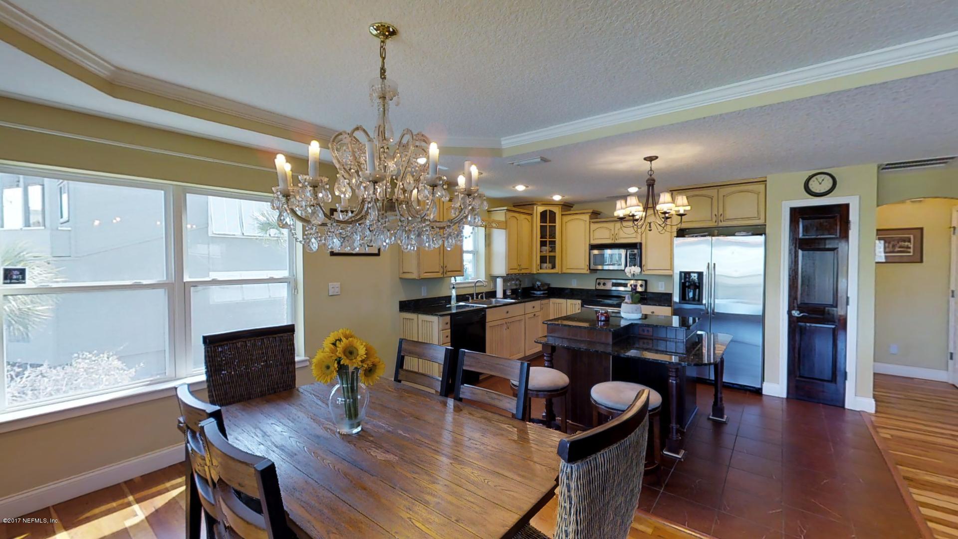 315 Genoa Road St. Augustine, FL 32084 - Photo 8 of 23 a dining room with furniture a chandelier and wooden floor