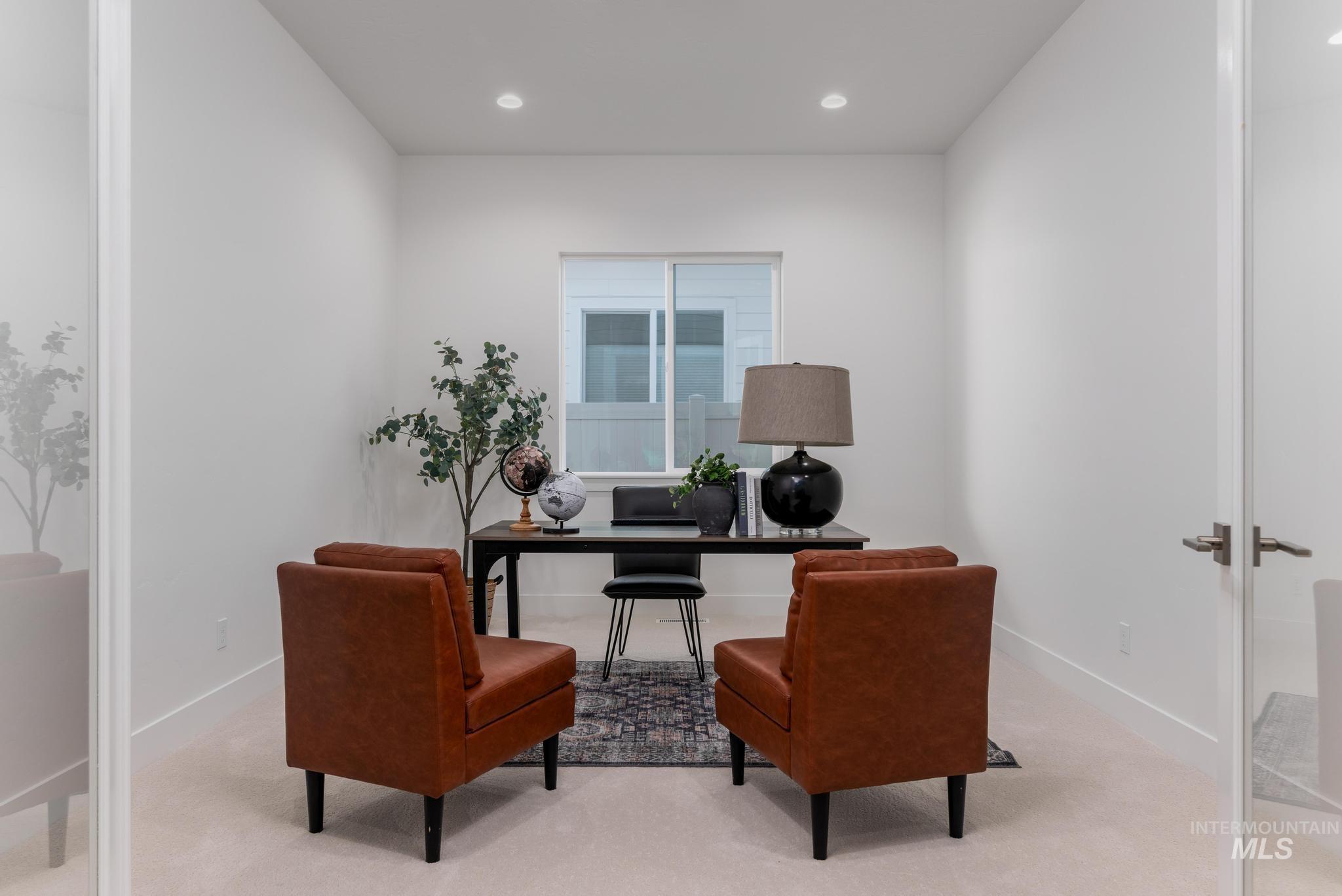 9074 West Moonglade Street Star, ID 83669 - Photo 4 of 40 Bright room with light-colored carpet flooring and white walls, featuring a large window, recessed lighting, and a glass panel door