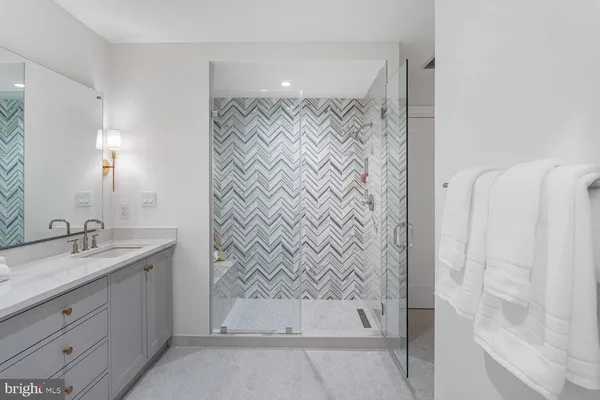 a kitchen with kitchen island a dining table chairs and white cabinets