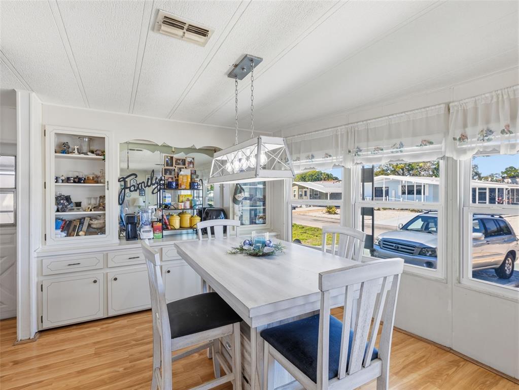 7402 Cascade Drive Hudson, FL 34667 - Photo 11 of 31 a view of a dining room with furniture window and wooden floor