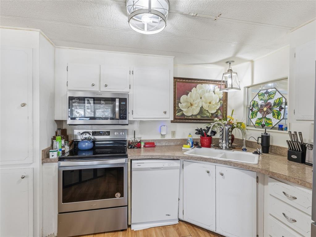 7402 Cascade Drive Hudson, FL 34667 - Photo 12 of 31 a kitchen with appliances a cabinets and counter space