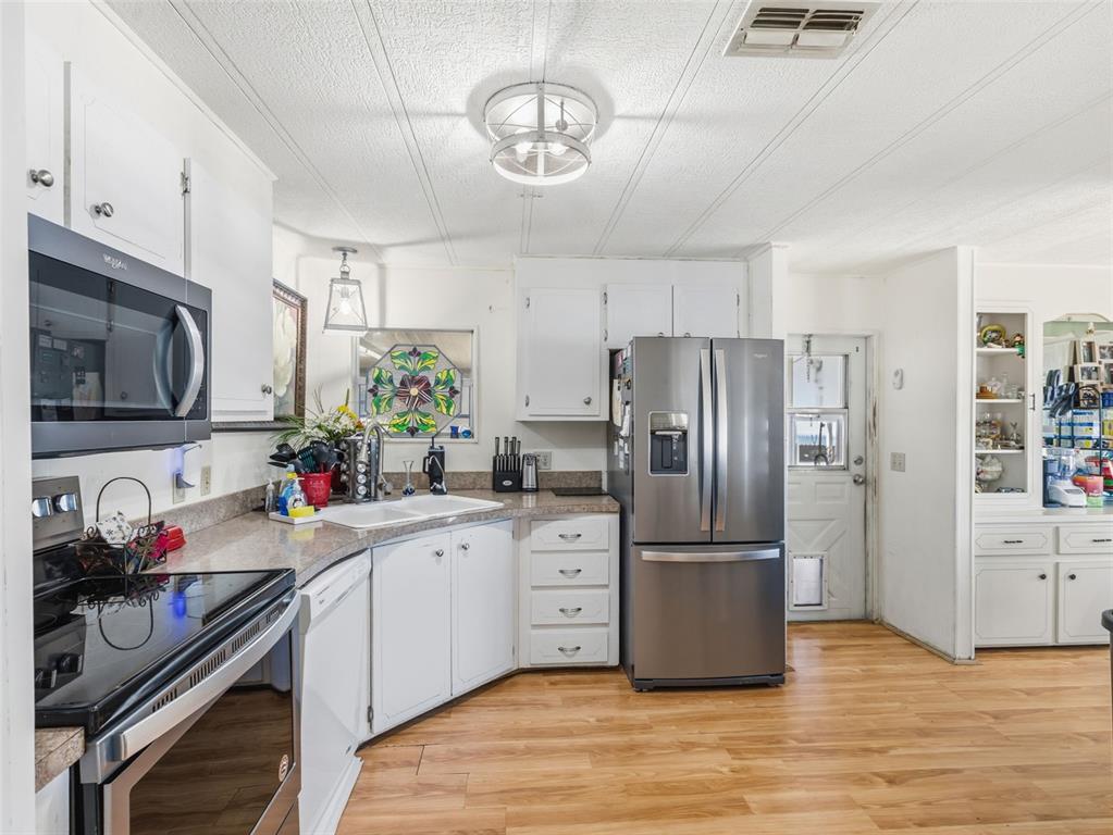 7402 Cascade Drive Hudson, FL 34667 - Photo 13 of 31 a kitchen with stainless steel appliances a sink stove and refrigerator