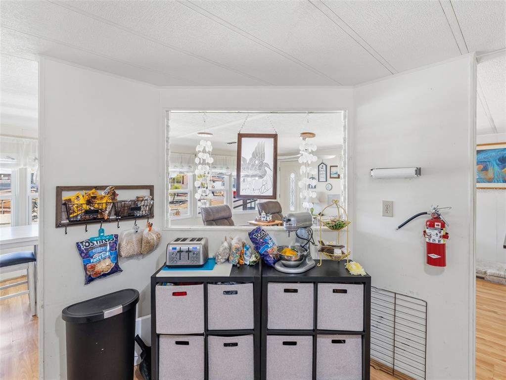 7402 Cascade Drive Hudson, FL 34667 - Photo 14 of 31 a kitchen with furniture a flat screen tv and a window