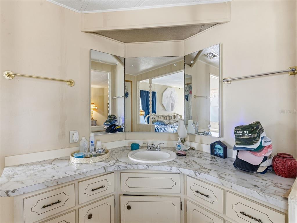 7402 Cascade Drive Hudson, FL 34667 - Photo 17 of 31 a bathroom with a granite countertop sink mirror and vanity