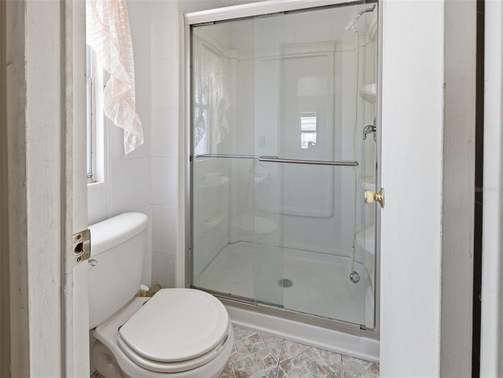 7402 Cascade Drive Hudson, FL 34667 - Photo 18 of 31 a white toilet next to a bathroom