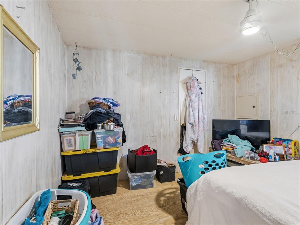 7402 Cascade Drive Hudson, FL 34667 - Photo 20 of 31 a bedroom with a bed a couch and dresser