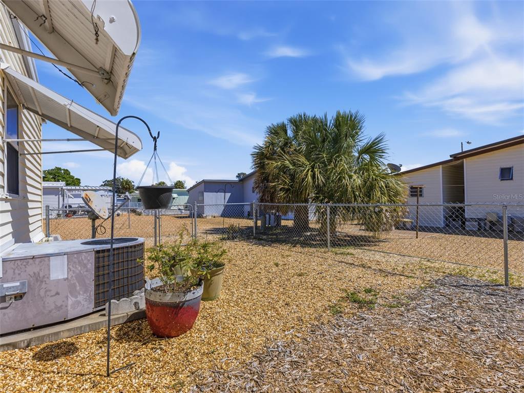 7402 Cascade Drive Hudson, FL 34667 - Photo 26 of 31 a backyard of a house with table and chairs