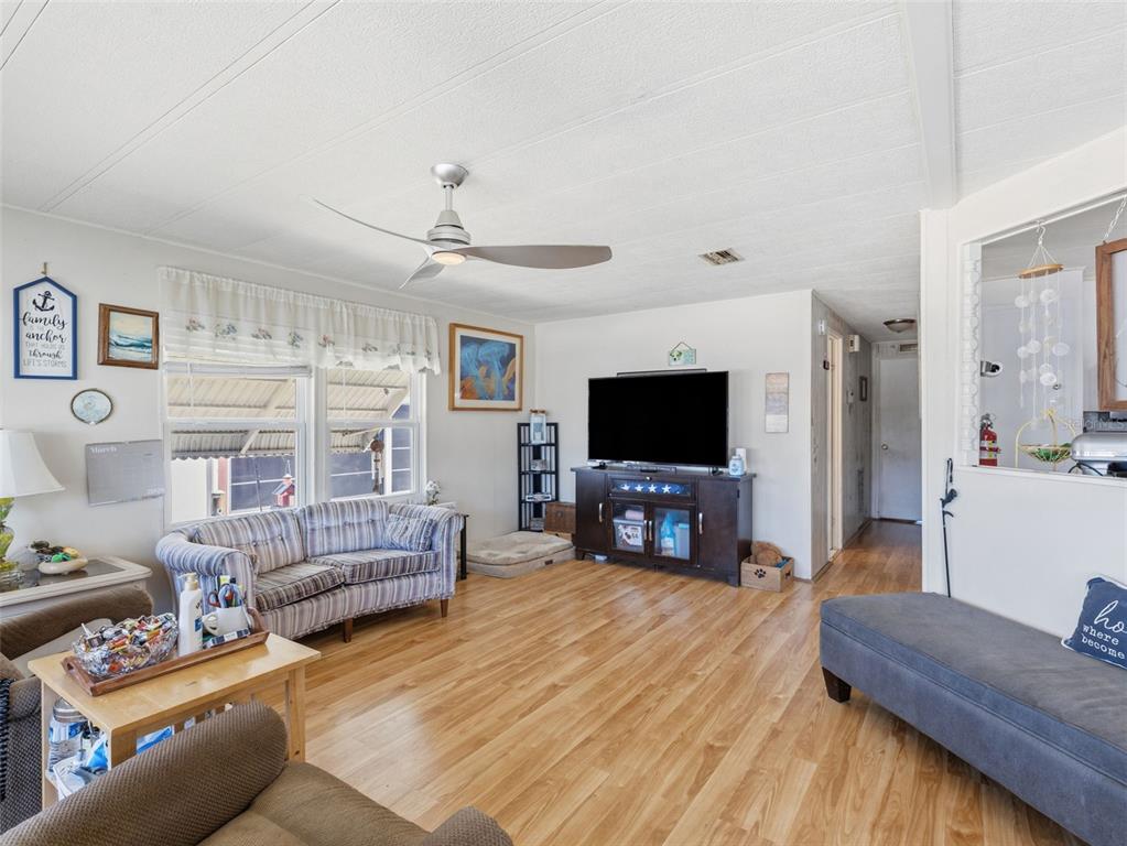 7402 Cascade Drive Hudson, FL 34667 - Photo 6 of 31 a living room with furniture and a flat screen tv