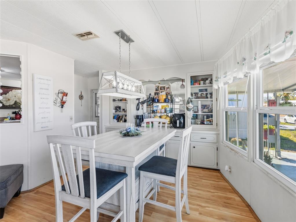 7402 Cascade Drive Hudson, FL 34667 - Photo 10 of 31 a view of a dining room with furniture and wooden floor