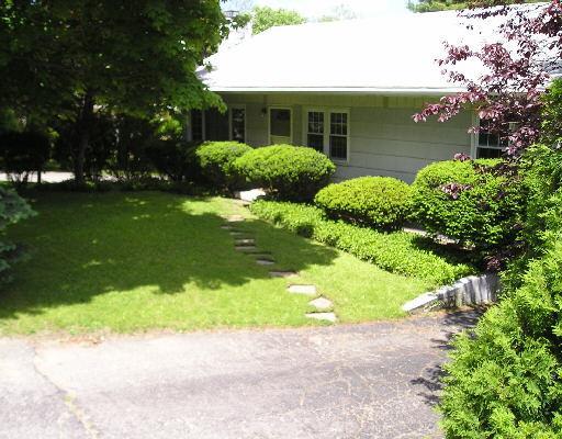 a view of a house with a garden and plants