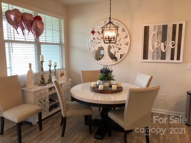 809 Gable Oak Lane, Unit 54 Tega Cay, SC 29708 - Photo 5 of 6 a view of a dining room with furniture window and wooden floor