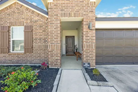 a view of a hallway view with wooden floor and staircase