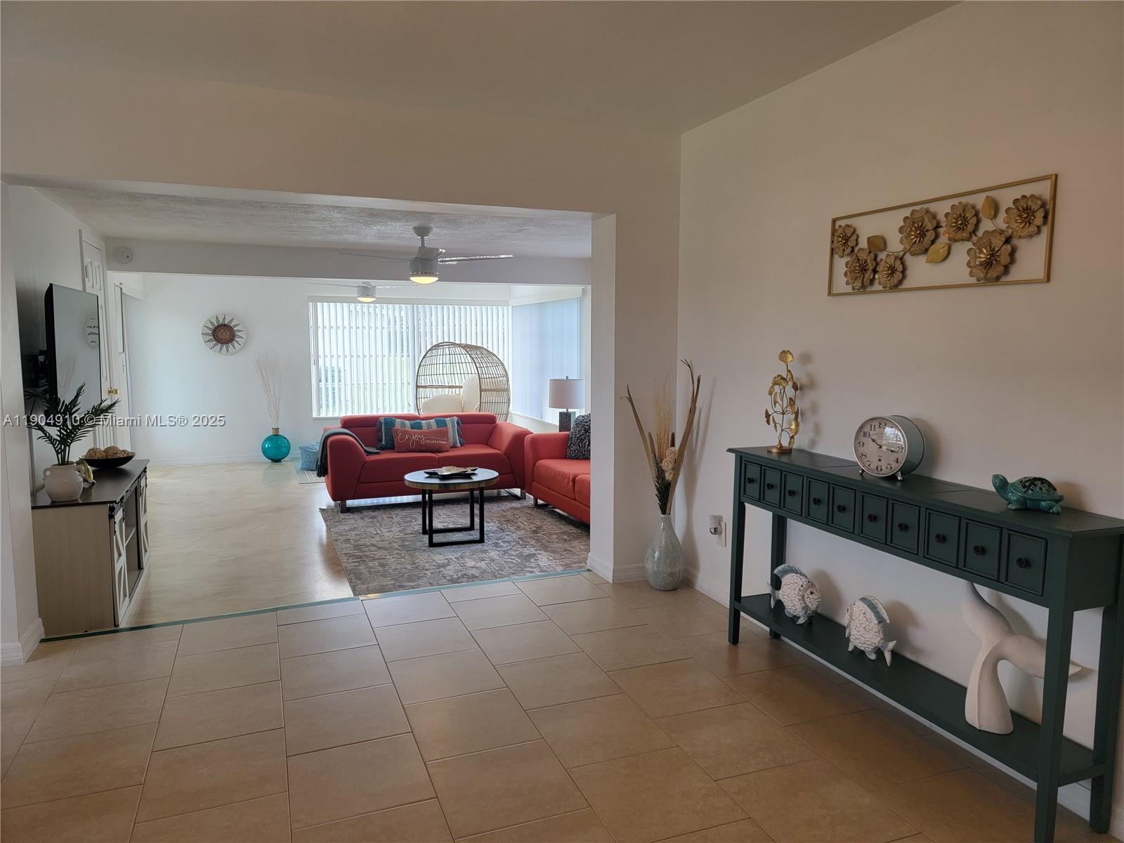 210 Banyan Drive Port St. Lucie, FL 34952 - Photo 11 of 22 a living room with furniture and a flat screen tv