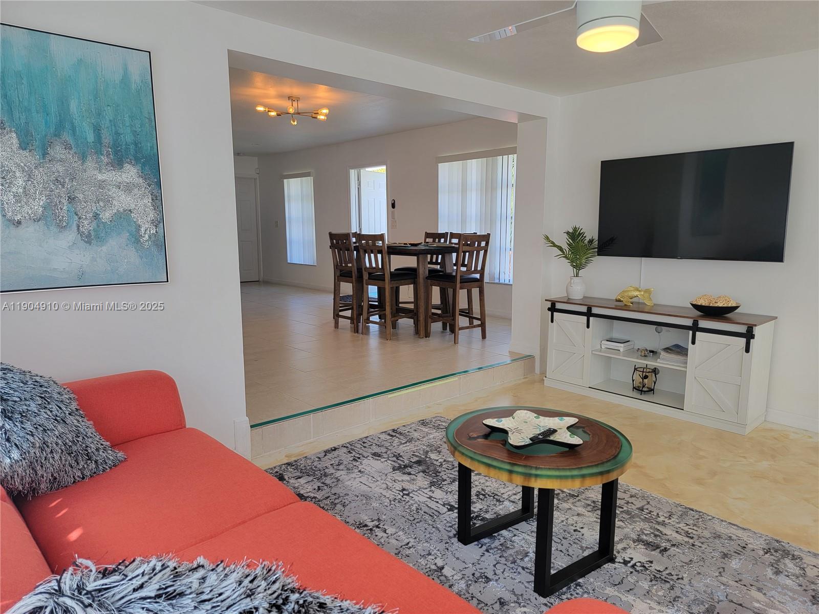 210 Banyan Drive Port St. Lucie, FL 34952 - Photo 12 of 22 a living room with furniture and a flat screen tv