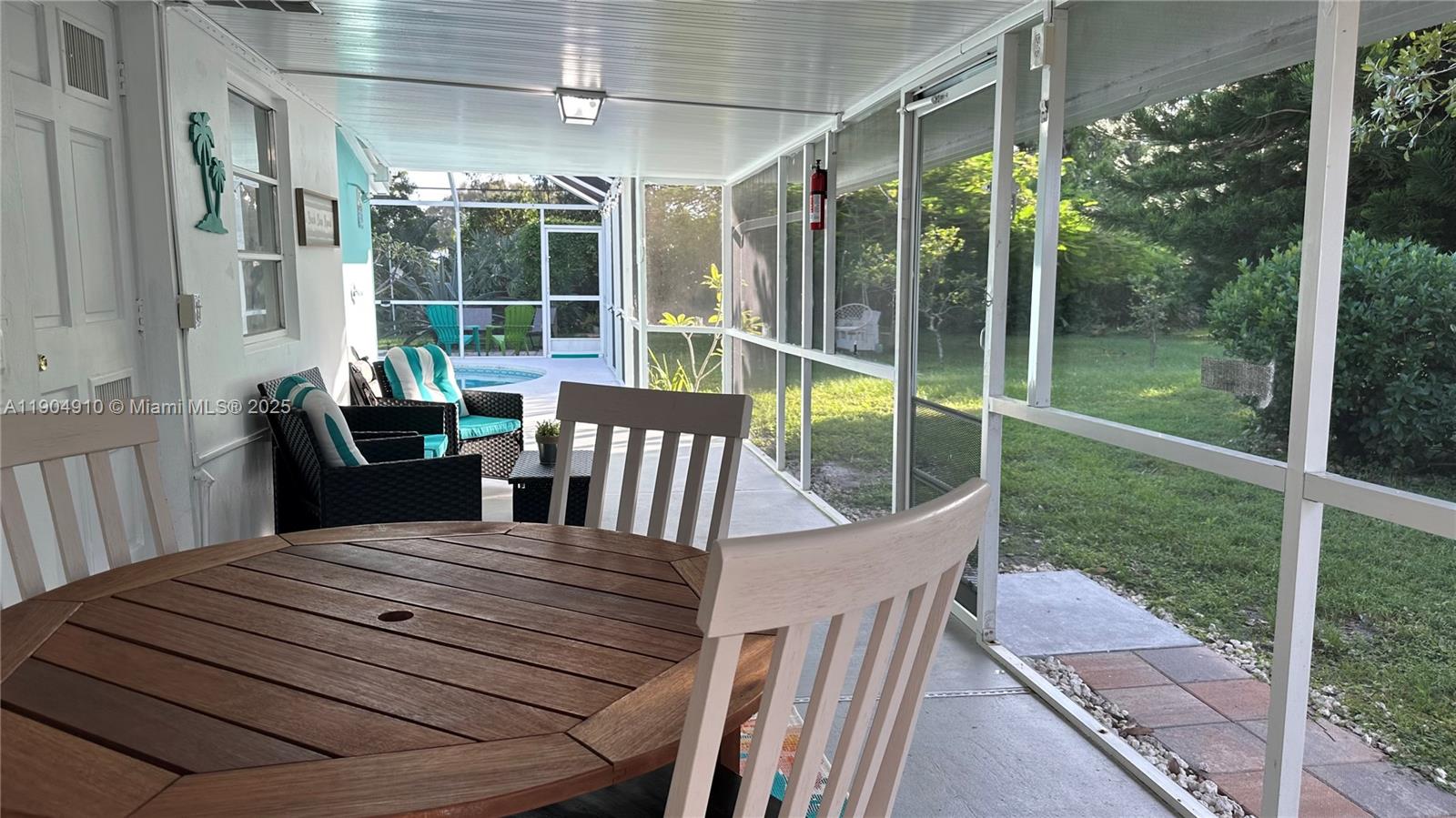 210 Banyan Drive Port St. Lucie, FL 34952 - Photo 19 of 22 a view of a patio with a table chairs and a backyard