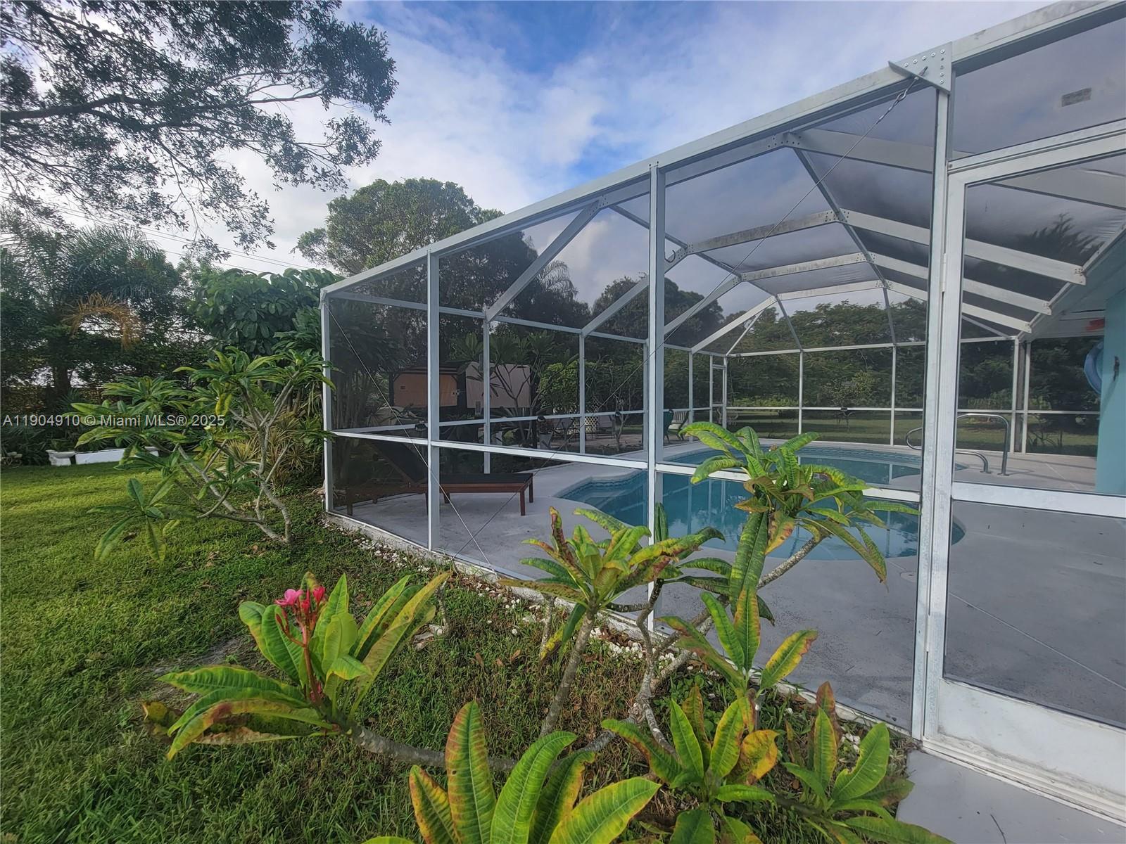 210 Banyan Drive Port St. Lucie, FL 34952 - Photo 21 of 22 a view of a chair and table in the garden