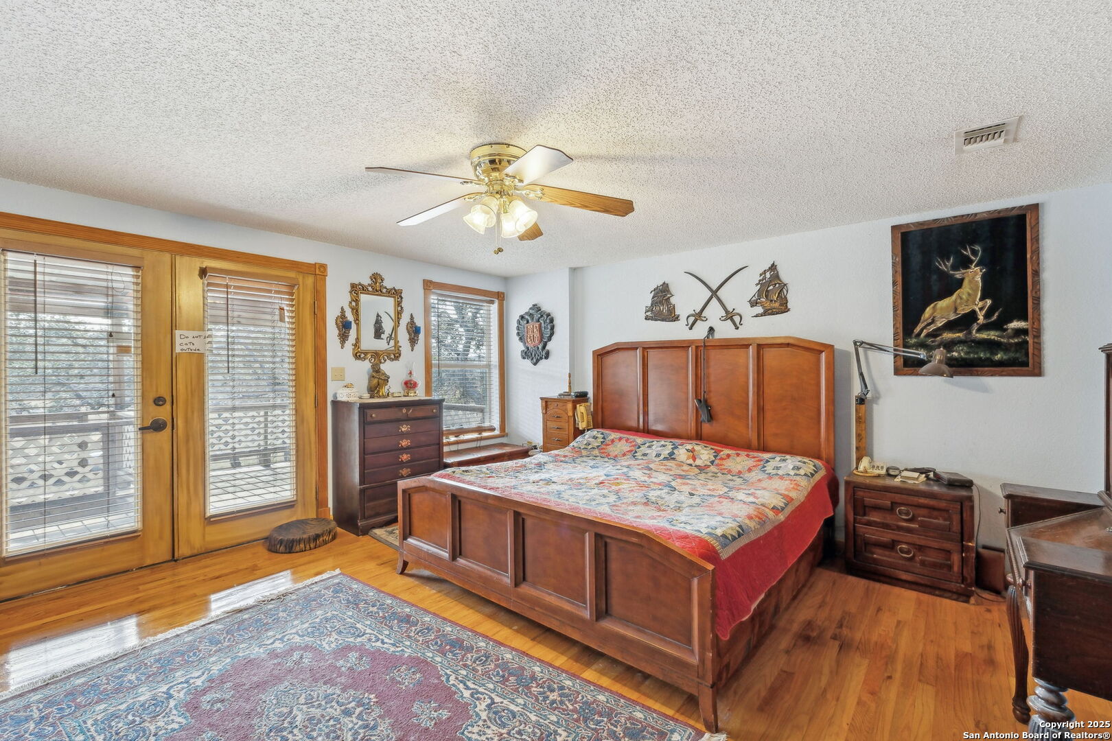 200 Highland Drive Bandera, TX 78003 - Photo 13 of 46 a living room with a bed and a dresser next to a window