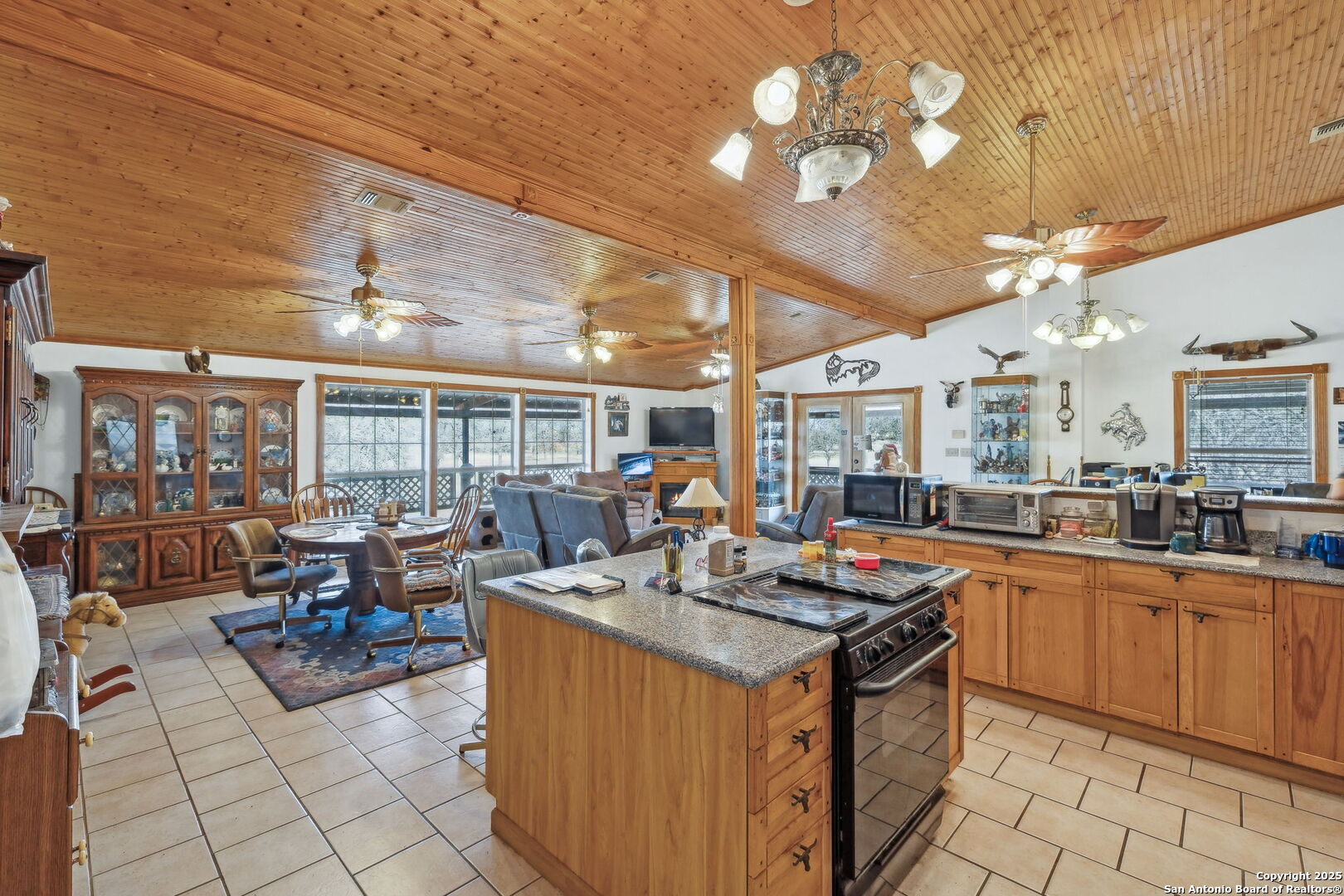 200 Highland Drive Bandera, TX 78003 - Photo 8 of 46 a view of a kitchen with granite countertop a stove a sink dishwasher with a dining table and chairs