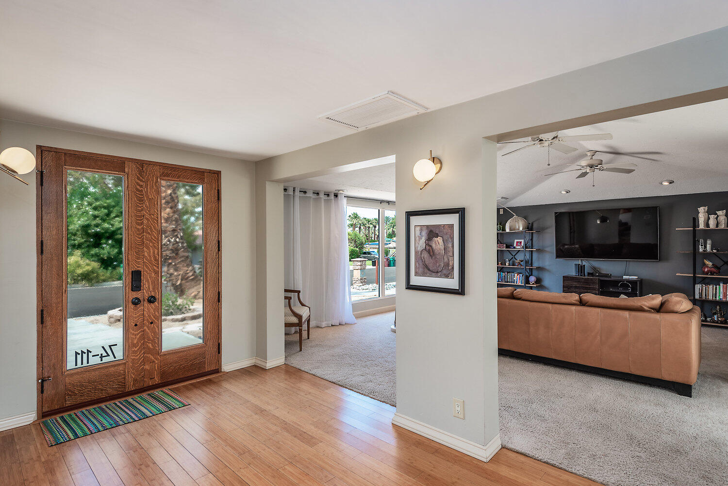 74111 Setting Sun Trail Palm Desert, CA 92260 - Photo 8 of 30 a living room with furniture and a flat screen tv