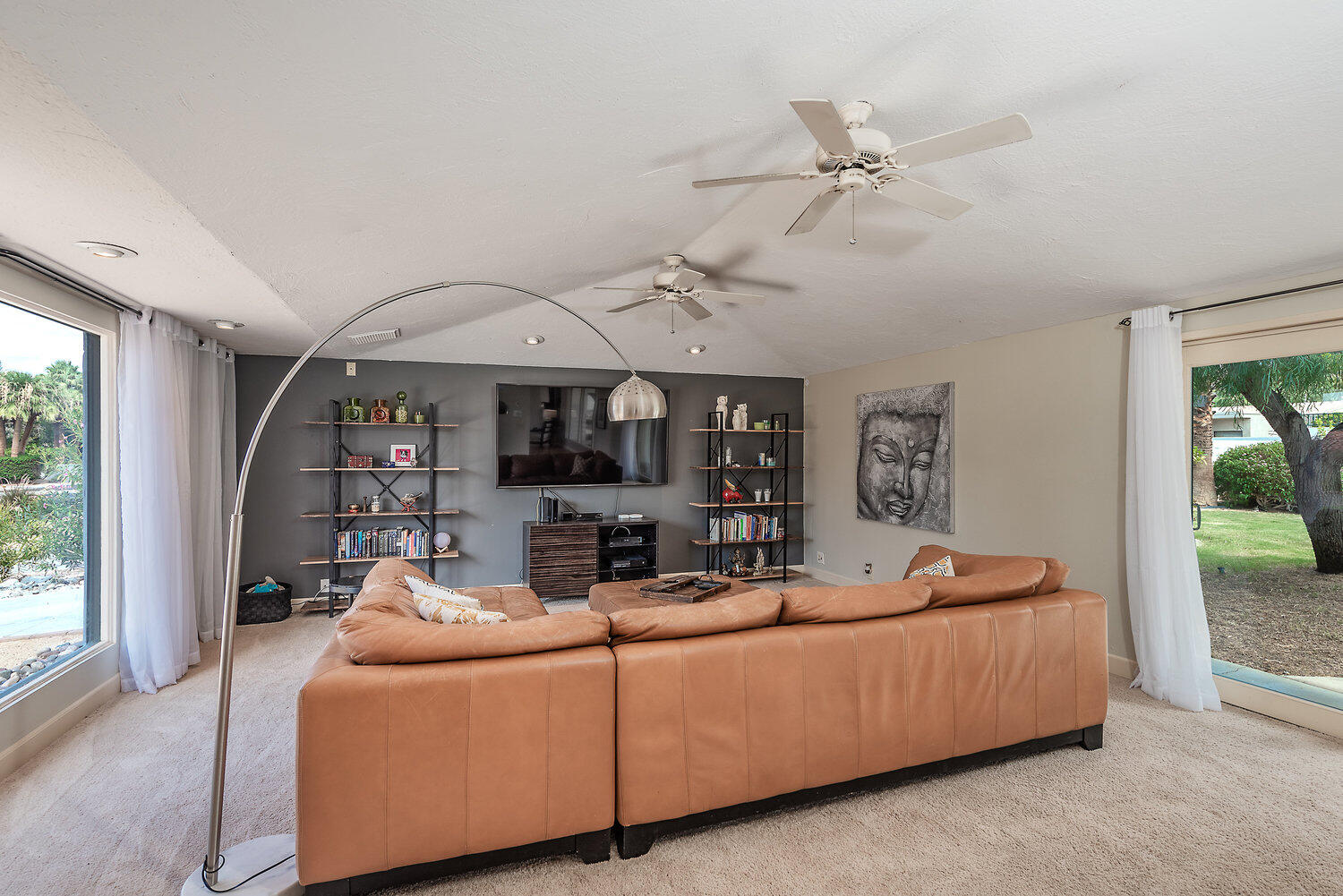 74111 Setting Sun Trail Palm Desert, CA 92260 - Photo 9 of 30 a living room with furniture and a ceiling fan