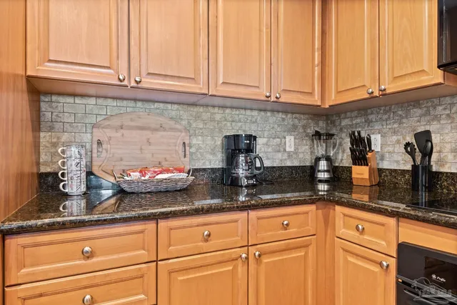 a kitchen with granite countertop stainless steel appliances sink and cabinets