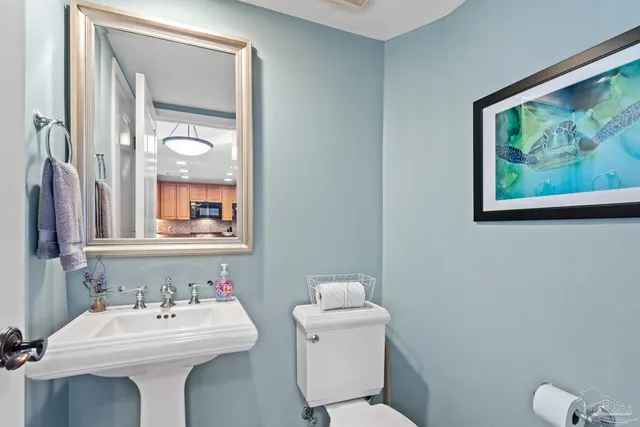 a bathroom with a toilet sink and mirror