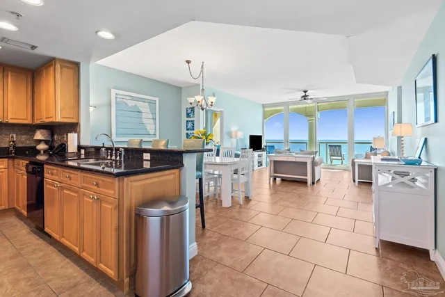 a kitchen with stainless steel appliances a stove a sink a oven a counter top space and cabinets